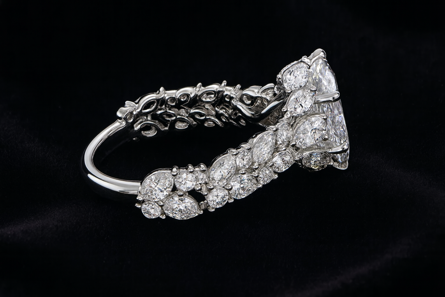 Diamond ring with a marquise-shaped center stone on a black velvet background