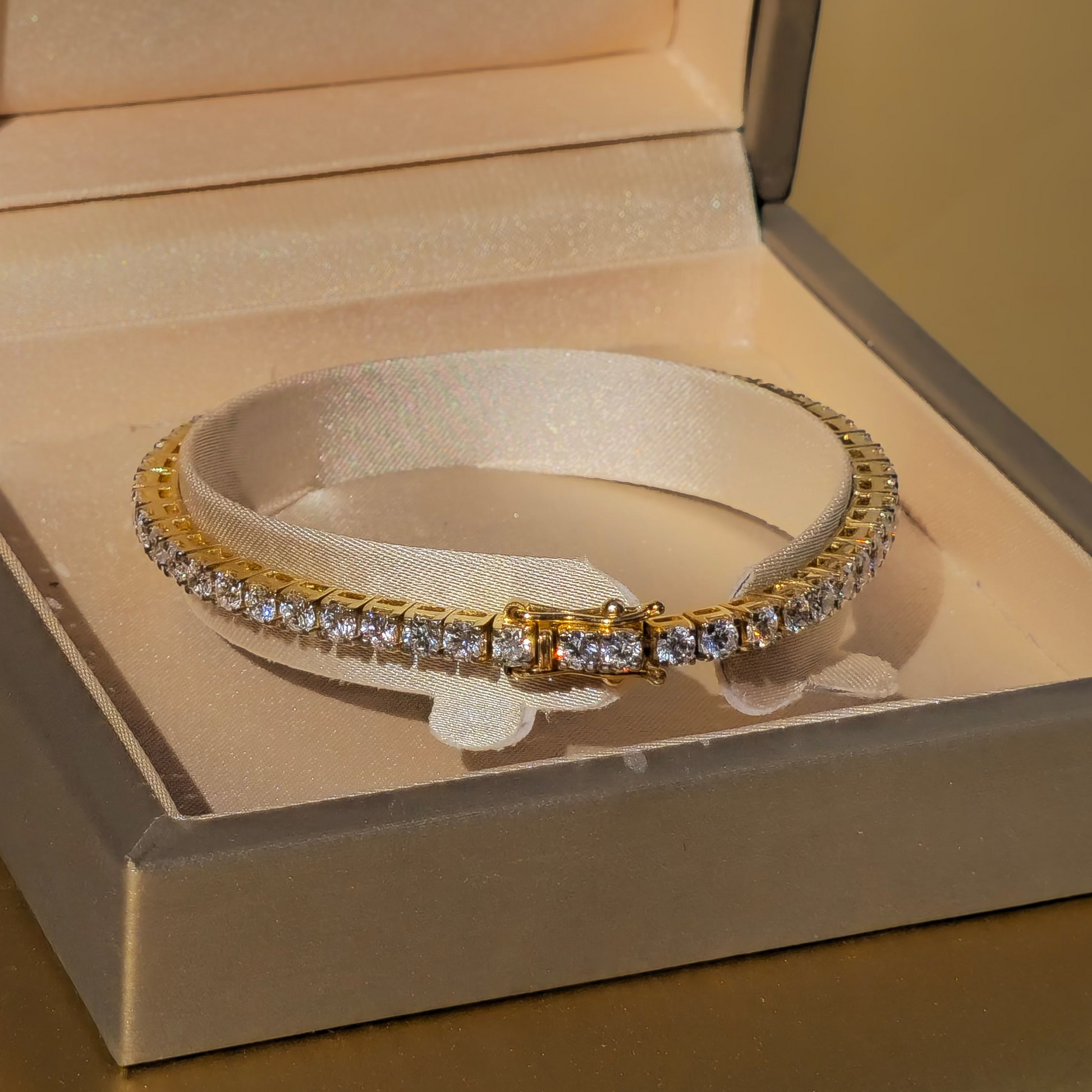 diamond gold bracelet in an open AviNika jewelry box.