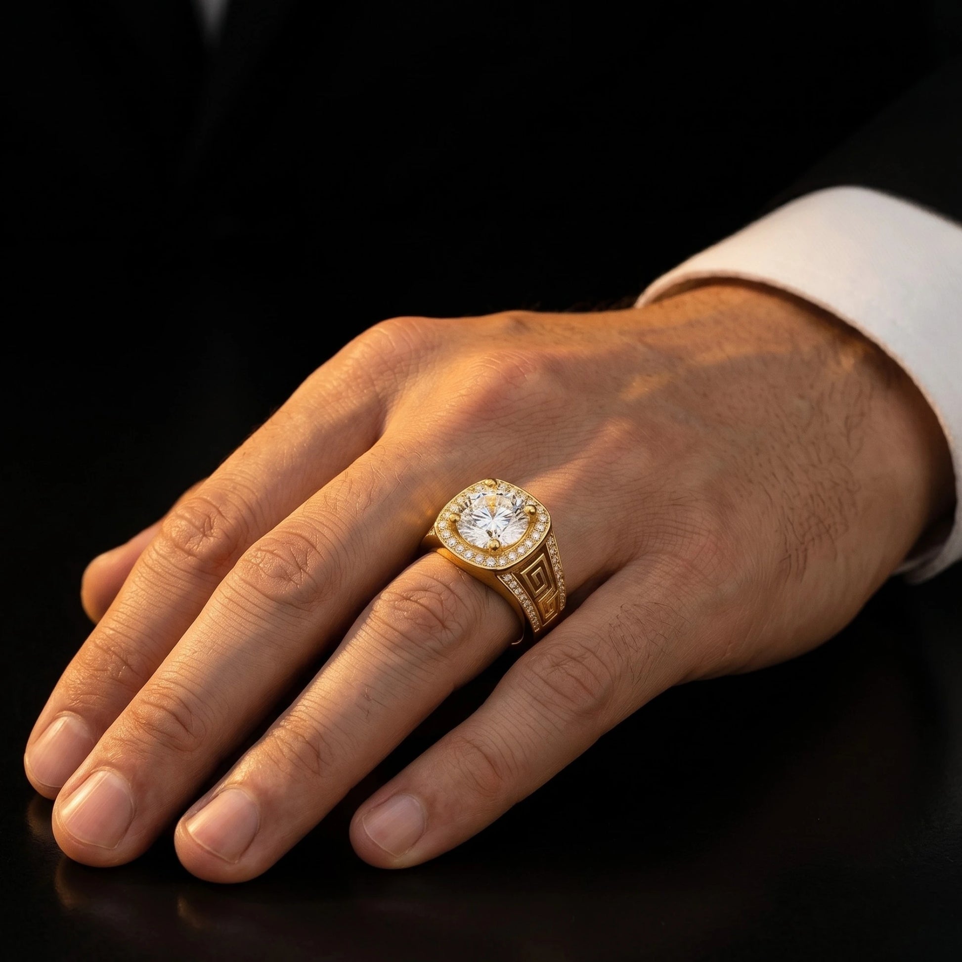 Men's 18K gold Greek key meander diamond halo ring worn on right hand against dark background, engraving detail visible, luxury fine jewelry by AviNika Jewelry