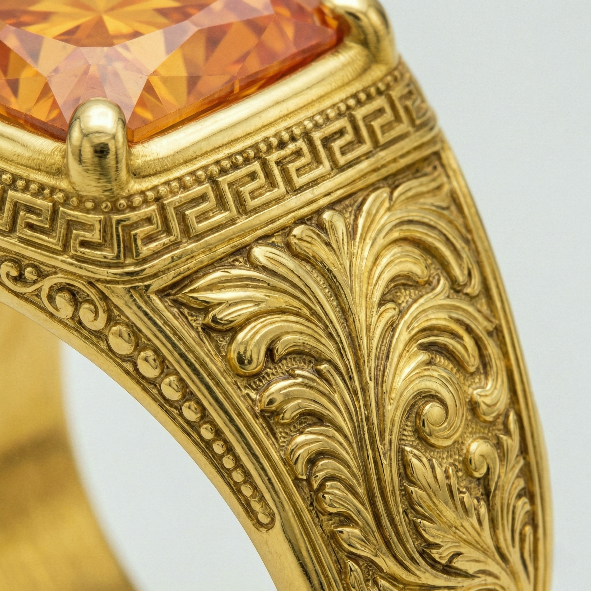 Hand-engraved Greek key meander border and Baroque acanthus scroll detail on an 18k yellow gold men's signet ring